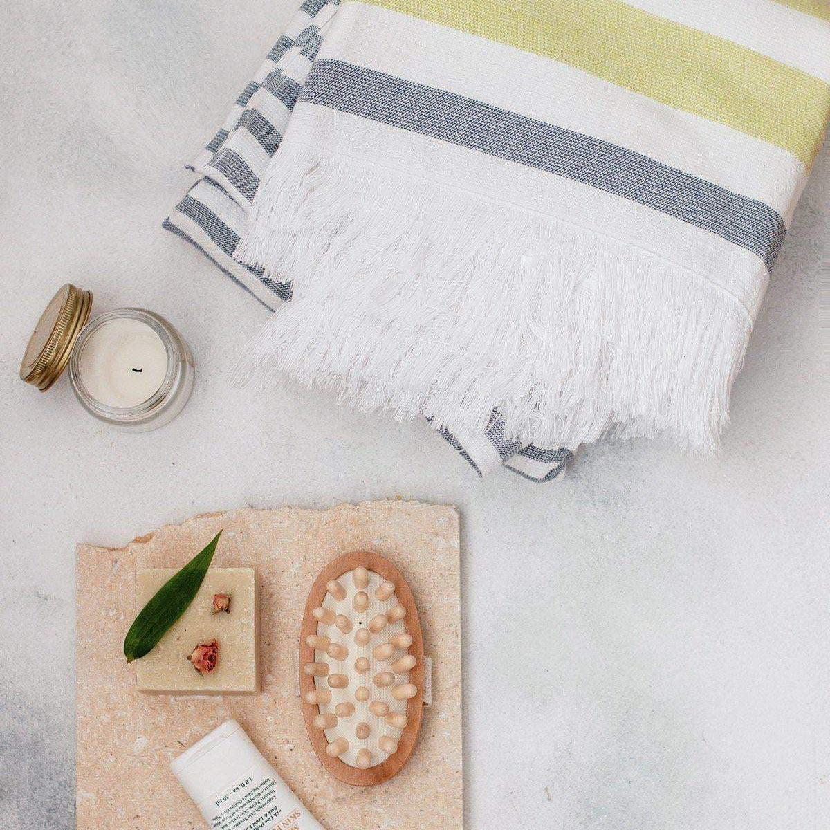 Luzia Peshtemal Beach and Pool Towel Shown with Personal Care Products