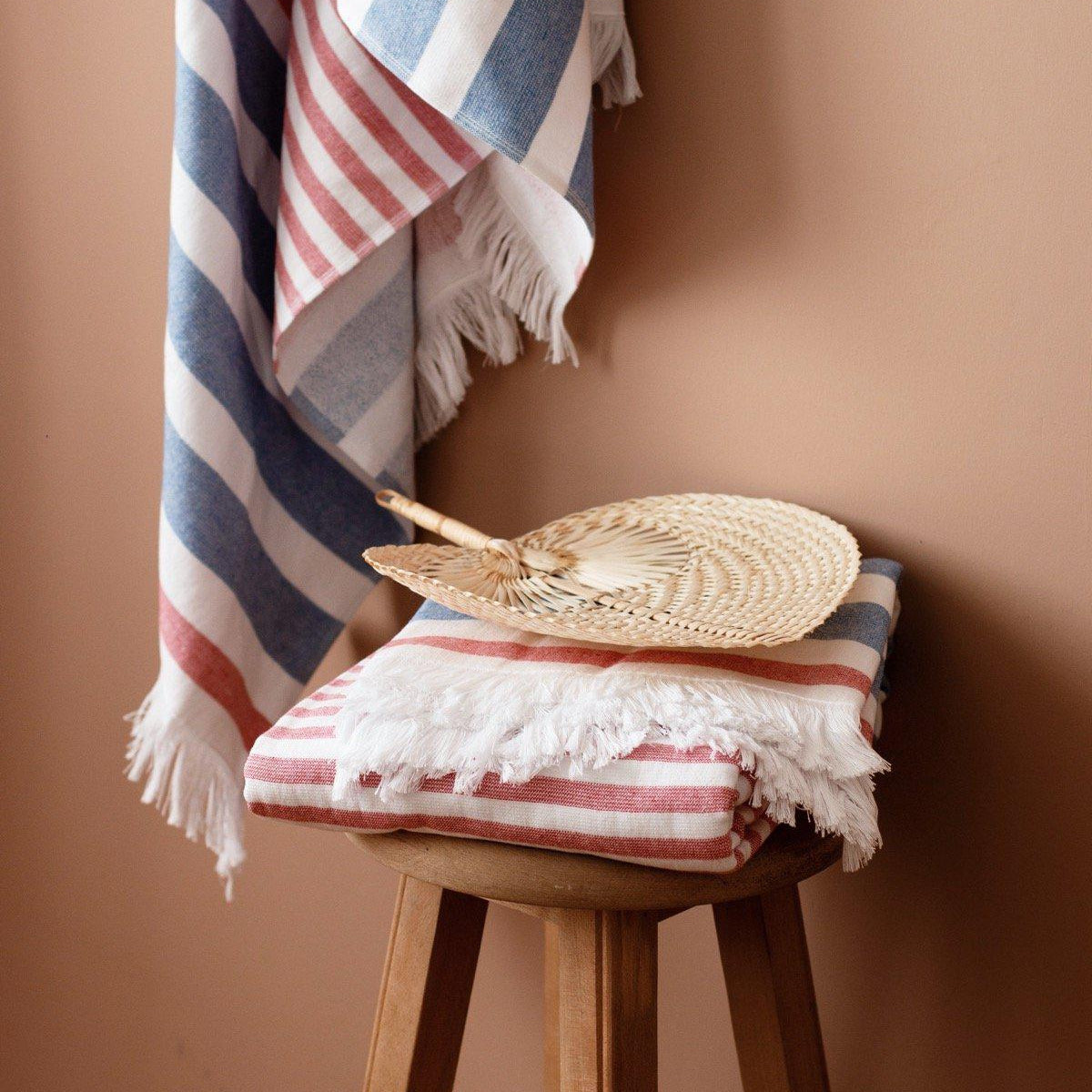 Luzia Peshtemal Beach and Pool Towel in Blue and Red Hung on Wall